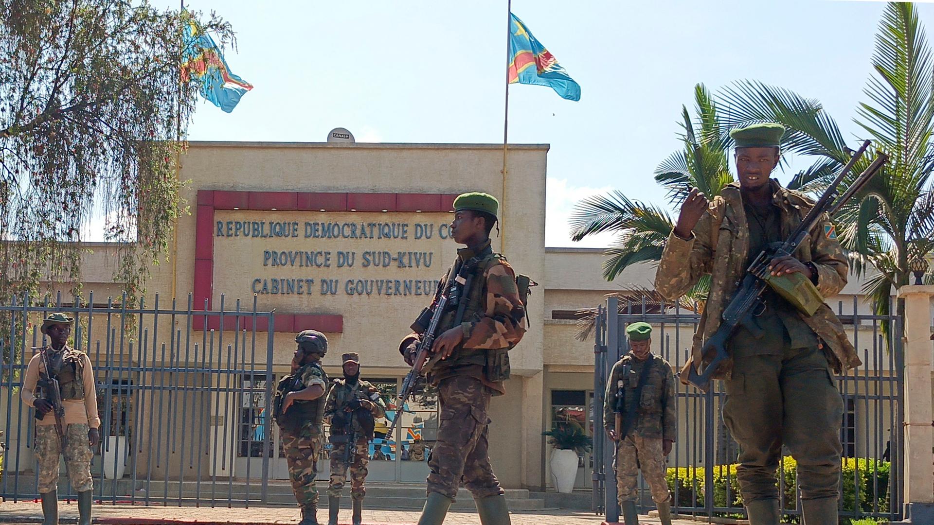 M23 rebels guard outside the South Kivu province administrative office, at the centre of east Congo's second-largest city, Bukavu