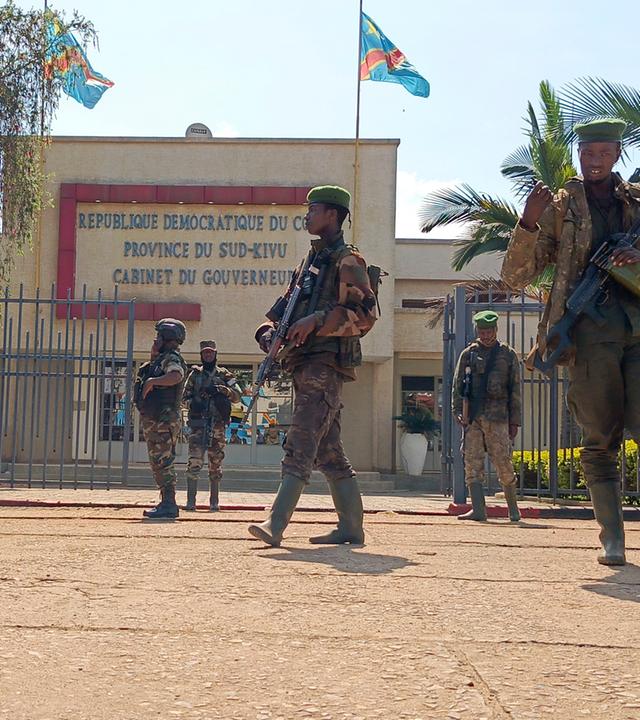 M23 rebels guard outside the South Kivu province administrative office, at the centre of east Congo's second-largest city, Bukavu