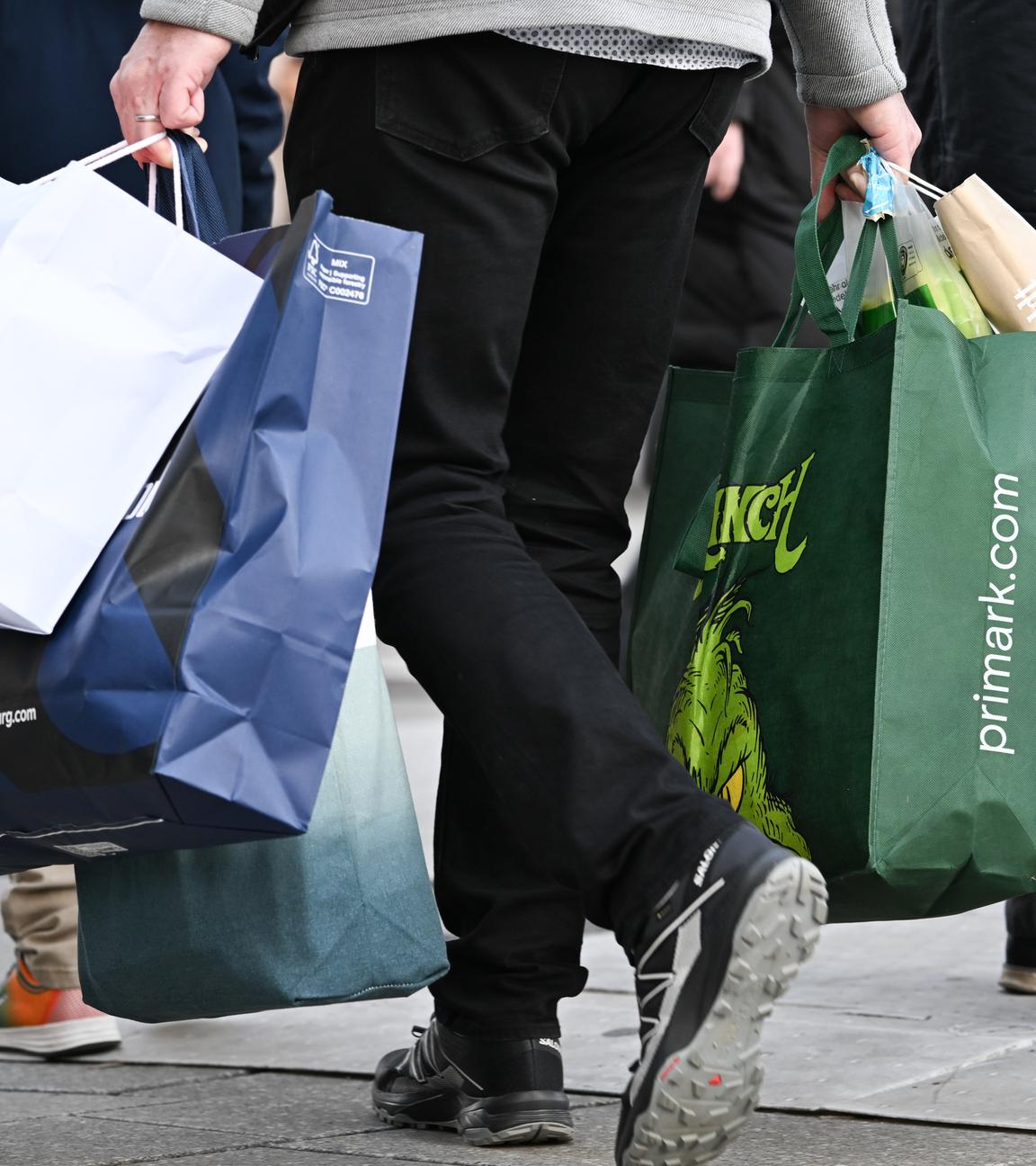 Ein Mann geht mit Tüten bepackt über die Frankfurter Einkaufsstraße Zeil.