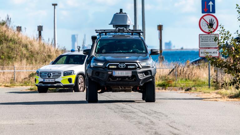 The police and members of the Danish Security and Intelligence Service (PET) inspect an area at DSB on Kystvejen near Copenhagen Airport in Copenhagen