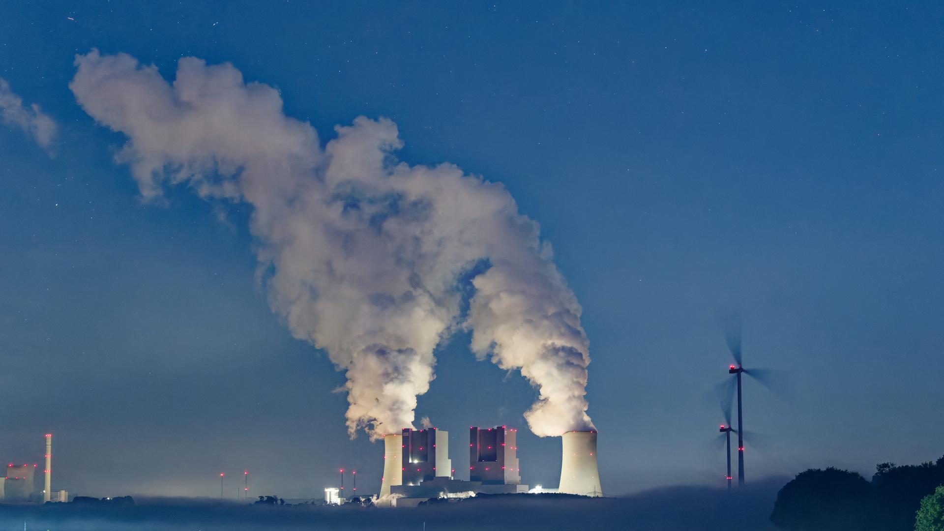 Symbolbild: Dampf steigt von den Kühltürmen des Braunkohlekraftwerkes Neurath am frühen Morgen in den Himmel.