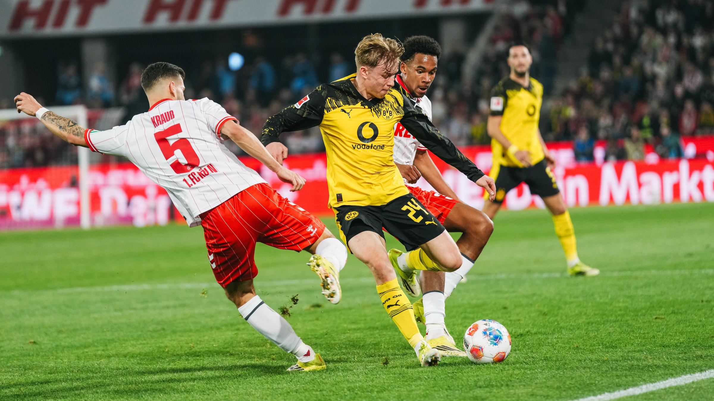 Dortmunds Verteidiger Daniel Svensson kann sich im Zweikampf gegen Kölns Tom Krauß und Youssoupha Niang durchsetzen