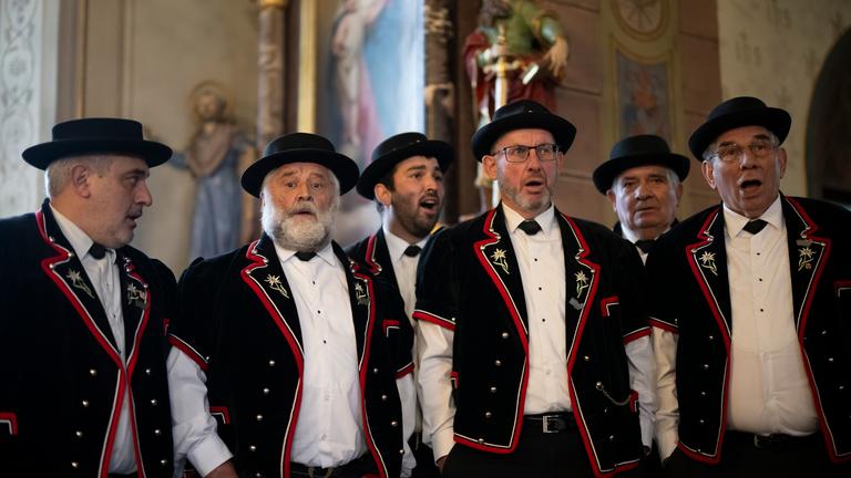 Members of the yodeling club named Jodelclub Stadtjodler Heimelig Frauenfeld perform in a church