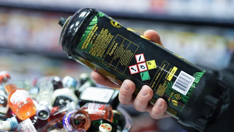  Ein Mitarbeiter hält eine Dose Lachgas am Tresen eines Hamburger Kiosks in der Hand.