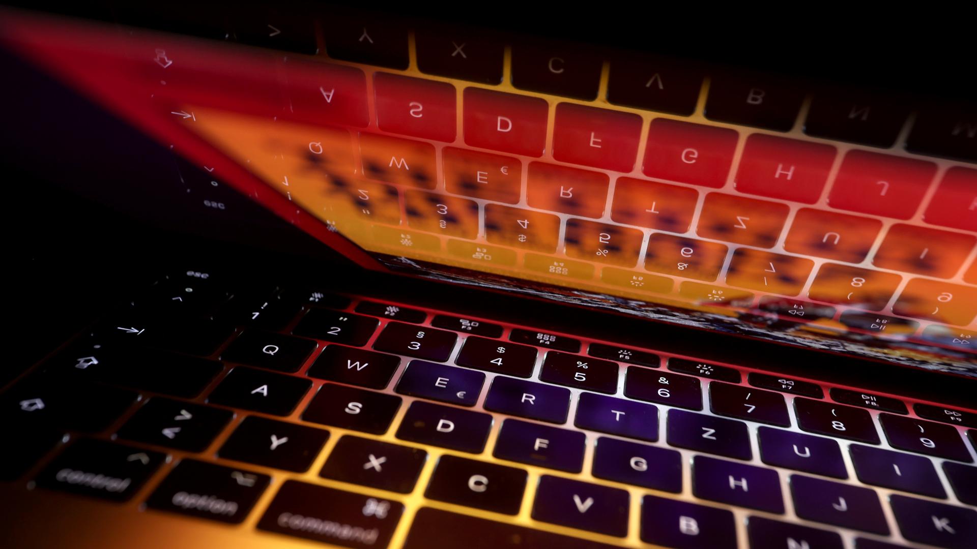 Die Tastatur eines Laptops spiegelt sich in dessen Bildschirm.