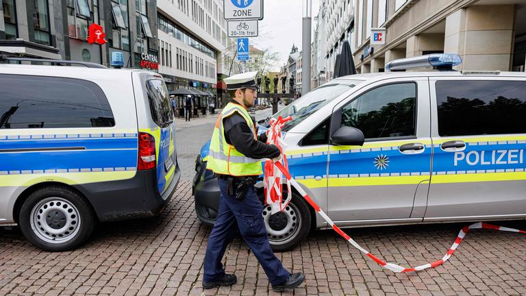 Ein Polizist entfernt die Absperrung am Eingang der Fußgängerzone der Grimmaischen Straße in Leipzig, aufgenommen am 05.05.2026