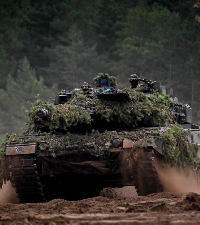 Ein Leopard-Kampfpanzer fährt durch den Wald 