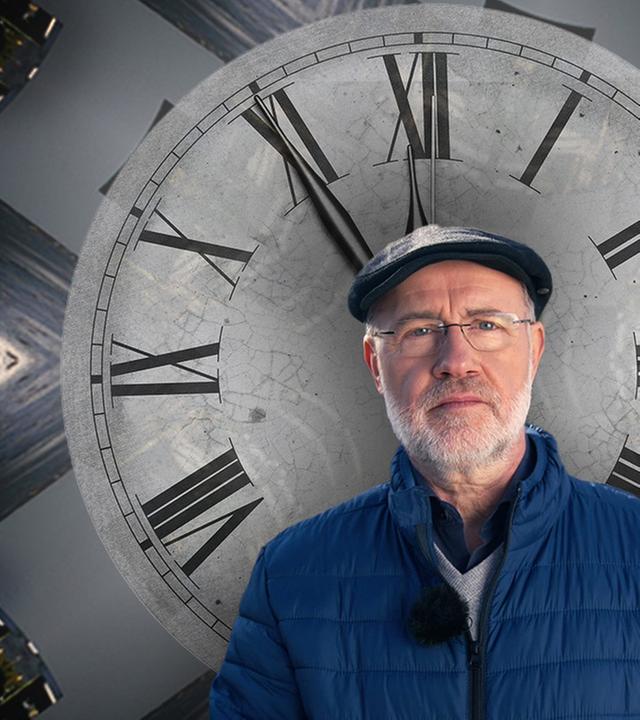 Harald Lesch steht vor einem Ziffernblatt