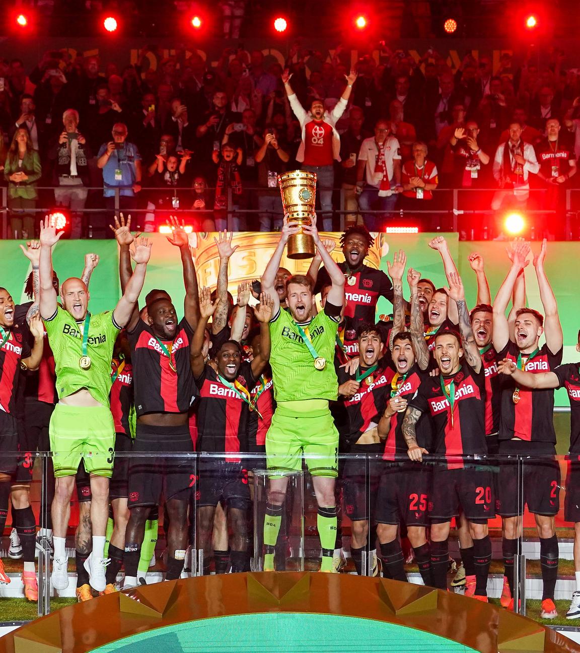 Bayer Leverkusens Spieler jubeln mit dem Pokal über das Double.