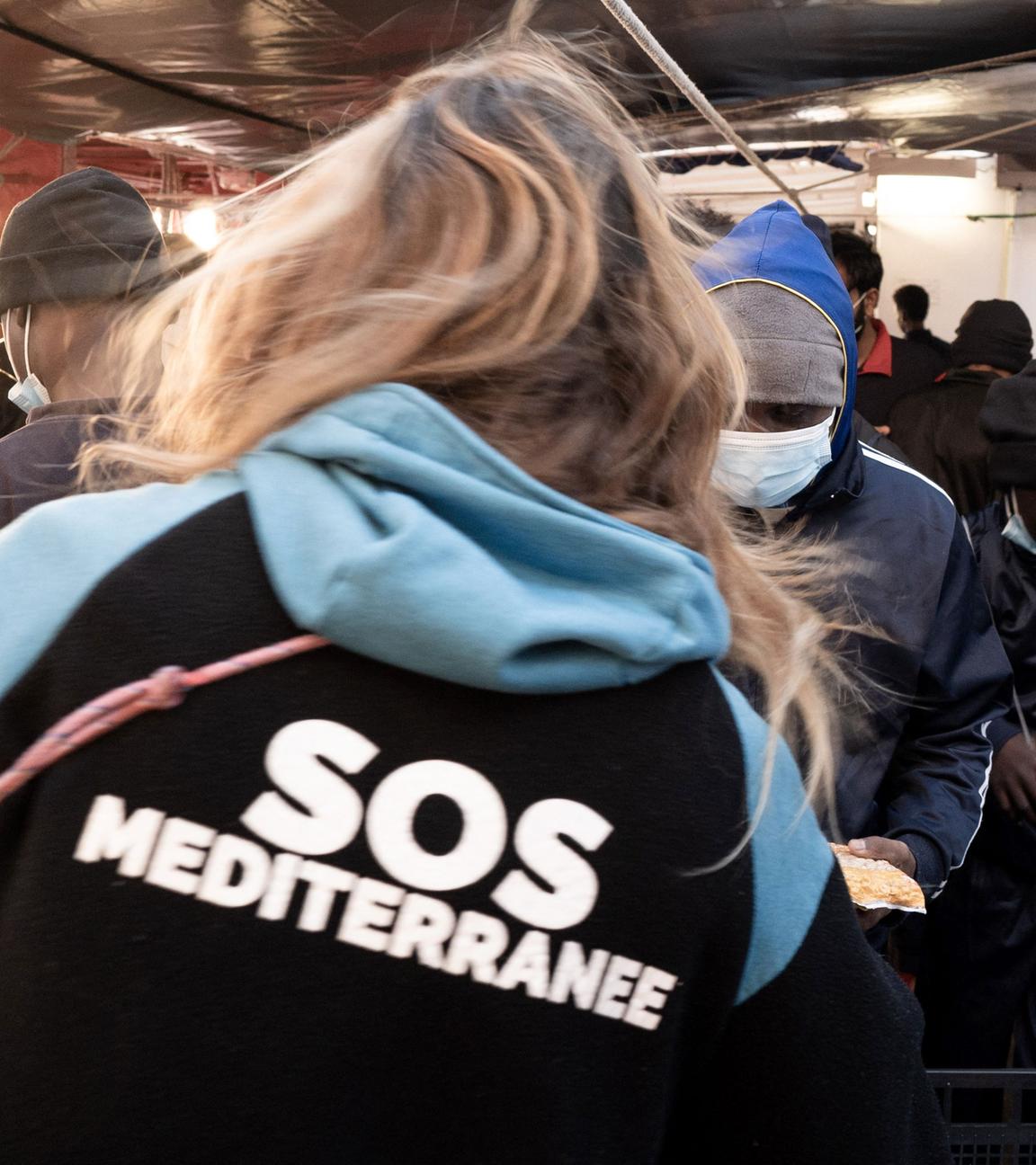 Migrants prepare to disembark from the Ocean Viking ship in Toulon on November 11, 2022, after being rescued by European maritime-humanitarian organization "SOS Mediterranee".