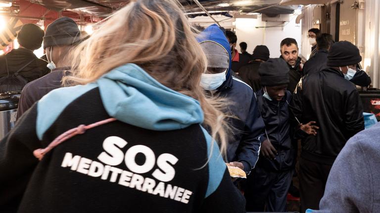Migrants prepare to disembark from the Ocean Viking ship in Toulon on November 11, 2022, after being rescued by European maritime-humanitarian organization "SOS Mediterranee".