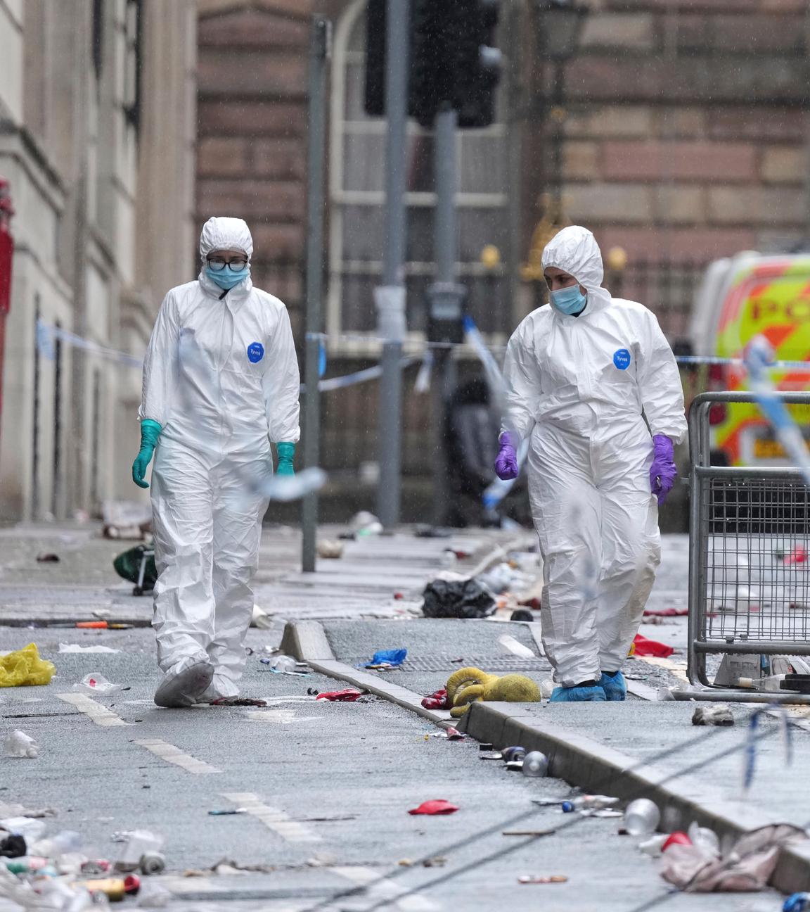 Forensic officers examine the site where a 53-year-old British man plowed a minivan into a crowd of Liverpool soccer fans who were celebrating the city's Premier League championship Monday, injuring more than 45 people in Liverpool, England, Tuesday, May 27, 2025.