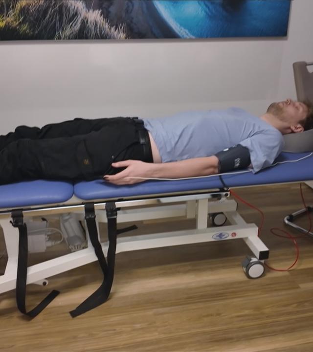 Mann liegt auf einer Liege in einem Untersuchungsraum.