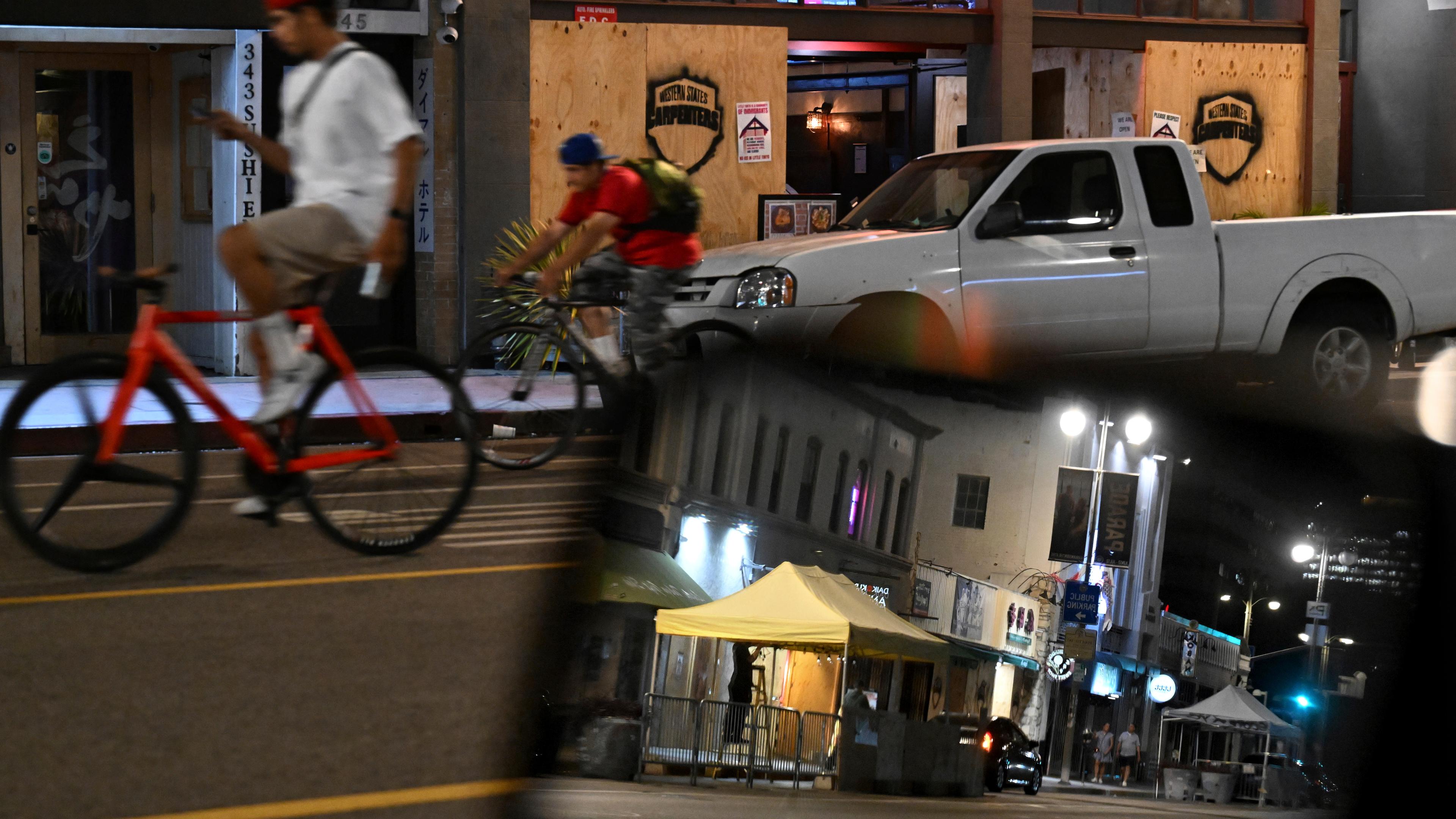 Fahrradfahrer fahren am Dienstag, den 17. Juni 2025, in Los Angeles an verrammelten Geschäften entlang der 1st St. in Little Tokyo vorbei.