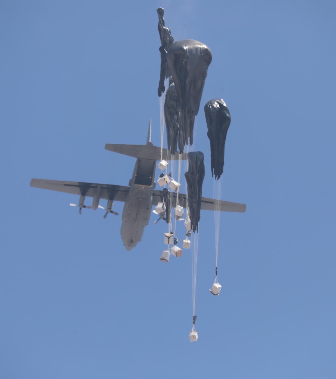 An airplane drops humanitarian aid over Gaza as seen from northern Gaza Strip.