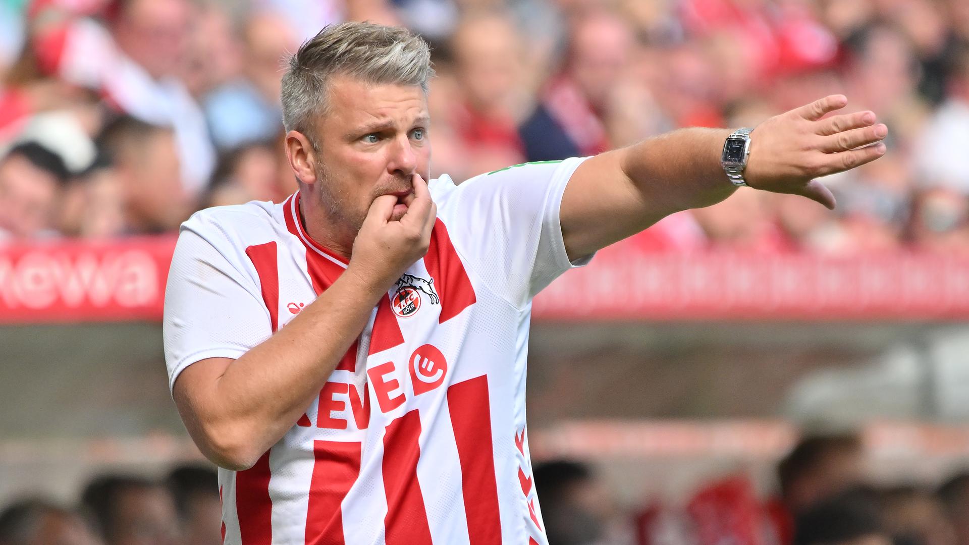 Lukas Kwasniok pfeift seine Spieler im Köln-Trikot nach vorne