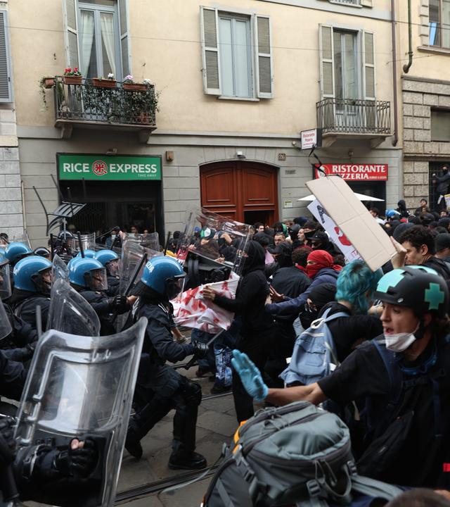 Bei Protesten in Mailand sieht man, wie die Polizei gegen die Demonstranten vorgeht.