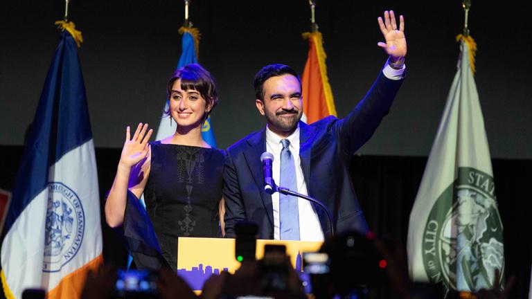 Zohran Mamdani and his wife Rama Duwaji wave to the crowd at the end of his victory speech as he won the race, in New York, NY,