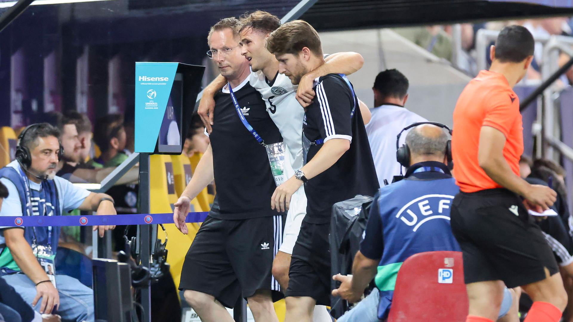 Der verletzte U21-Abwehrchef Max Rosenfelder wird im EM-Halbfinale gegen Frankreich von zwei Betreuern gestützt