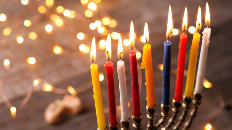 Menora mit bunten Kerzen - Symbolbild
