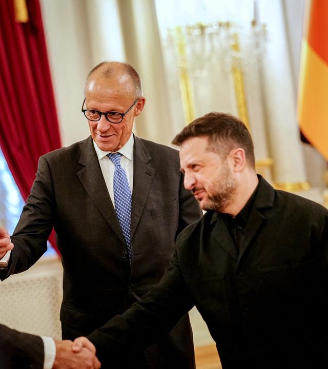 Wolodymyr Selenskyj, Präsident der Ukraine, und Bundeskanzler Friedrich Merz (l, CDU) bei einem Empfang im Präsidentenpalast.