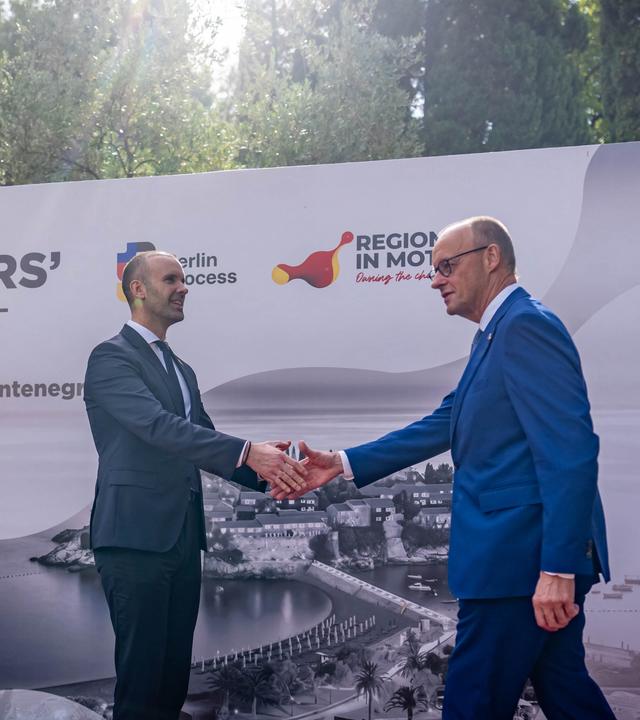 Bundeskanzler Friedrich Merz (CDU) wird von Milojko Spajic, Ministerpräsident von Montenegro zum Westbalkangipfel in Sveti Stefan begrüsst.