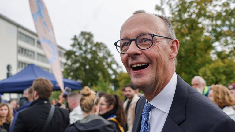 German Chancellor Friedrich Merz reacts during a tour after celebrations for the Day of German Unity 2025 in Saarbruecken