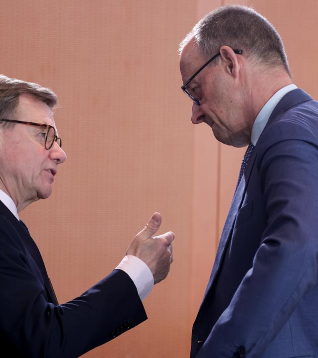 German Foreign Minister Johann Wadephul (L) talks with German Chancellor Friedrich Merz during the weekly cabinet meeting of the German government in Berlin, Germany, 01 April 2026.