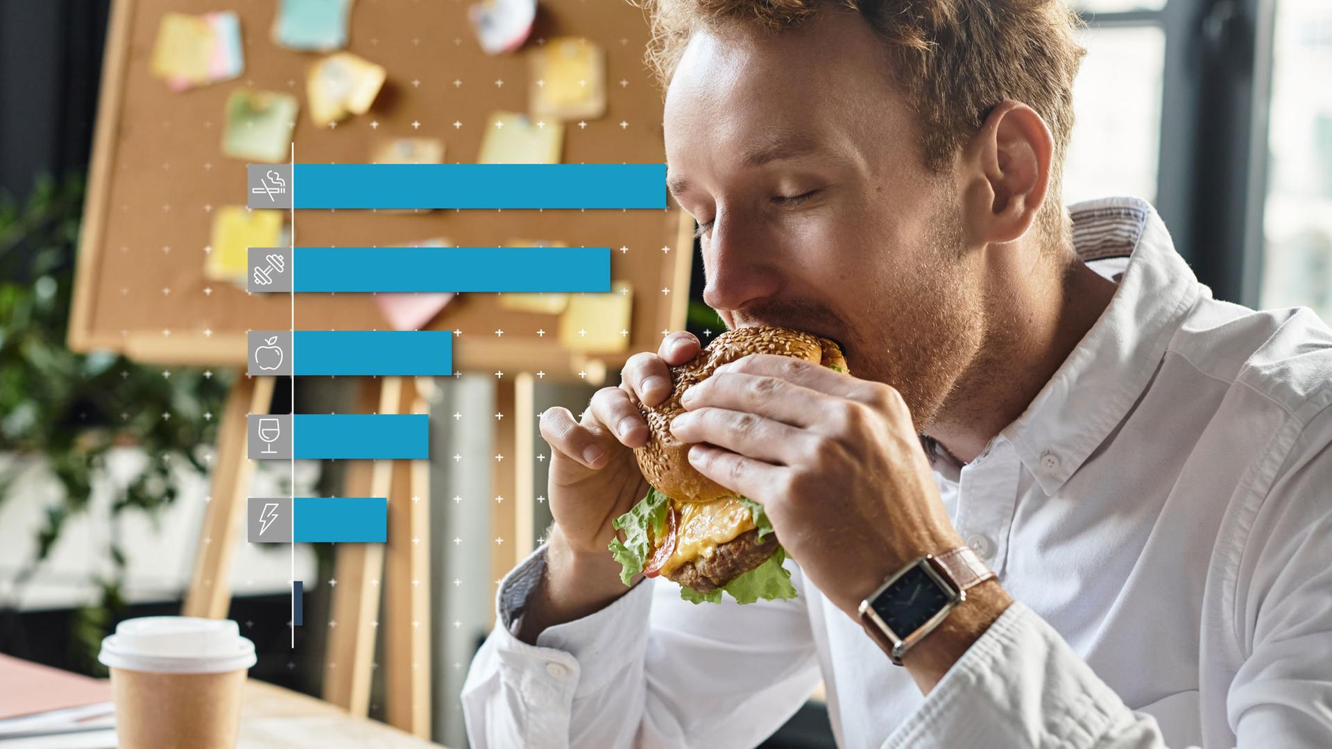 Ein Mann isst einen Hamburger im Büro.