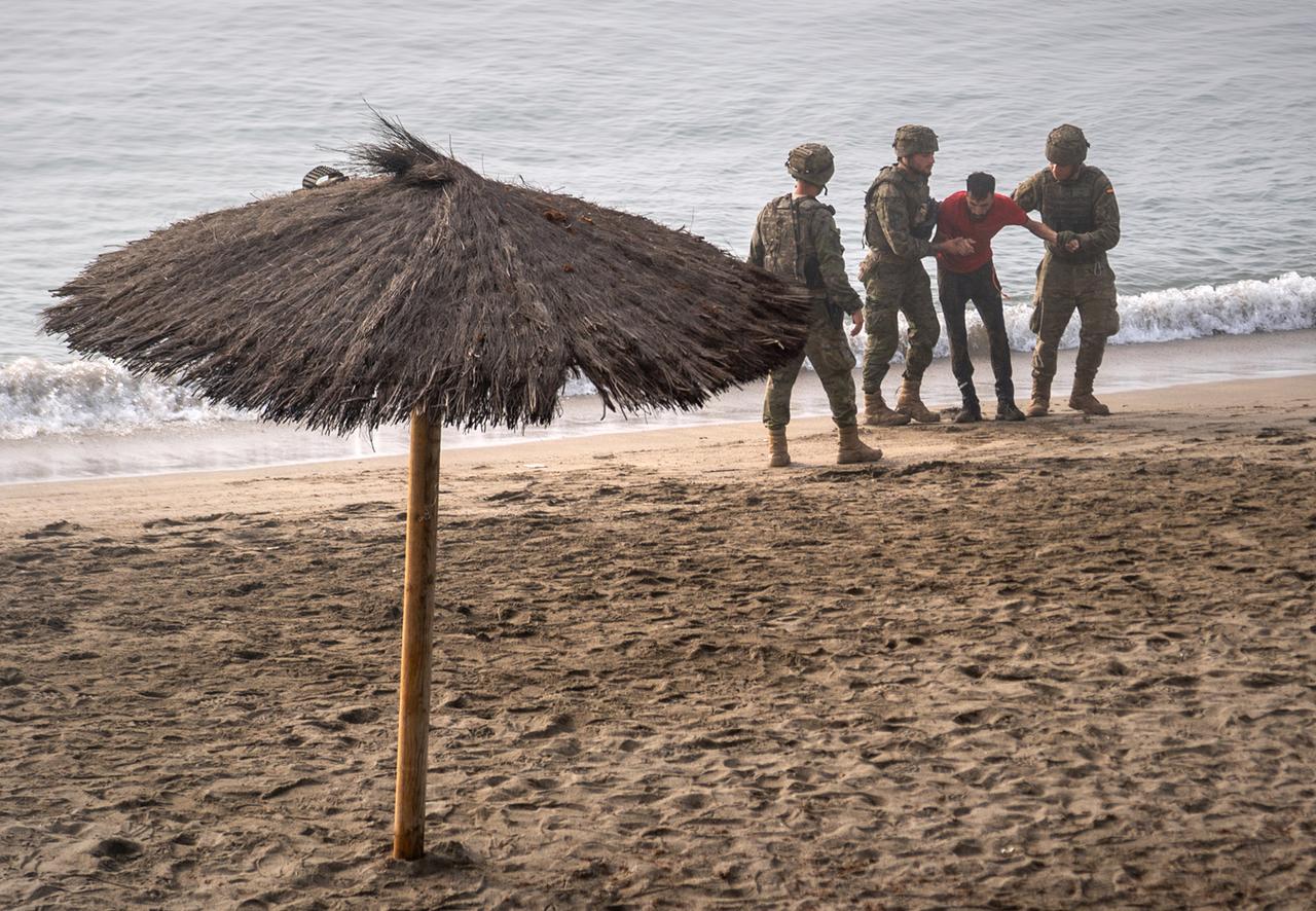 Spanien, Ceuta: Soldaten der spanischen Armee leisten einem Migranten Hilfe, der von Marokko aus zur spanischen Exklave Ceuta geschwommen ist.