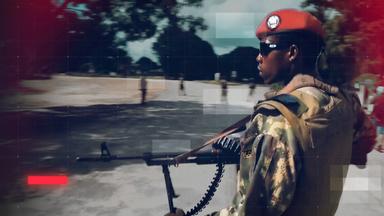 Eine Sldat der der mosambikanischen Armee  in Tarnuniform mit rotem Barett und Sonnenbrille trägt ein Gewehr und bewegt sich im Freien. Das Bild ist mit grafischen Raster-Overlay und rote Lichteffekten gestaltet und vermittelt den Eindruck einer Nachrichten- oder Dokumentationsaufnahme.
