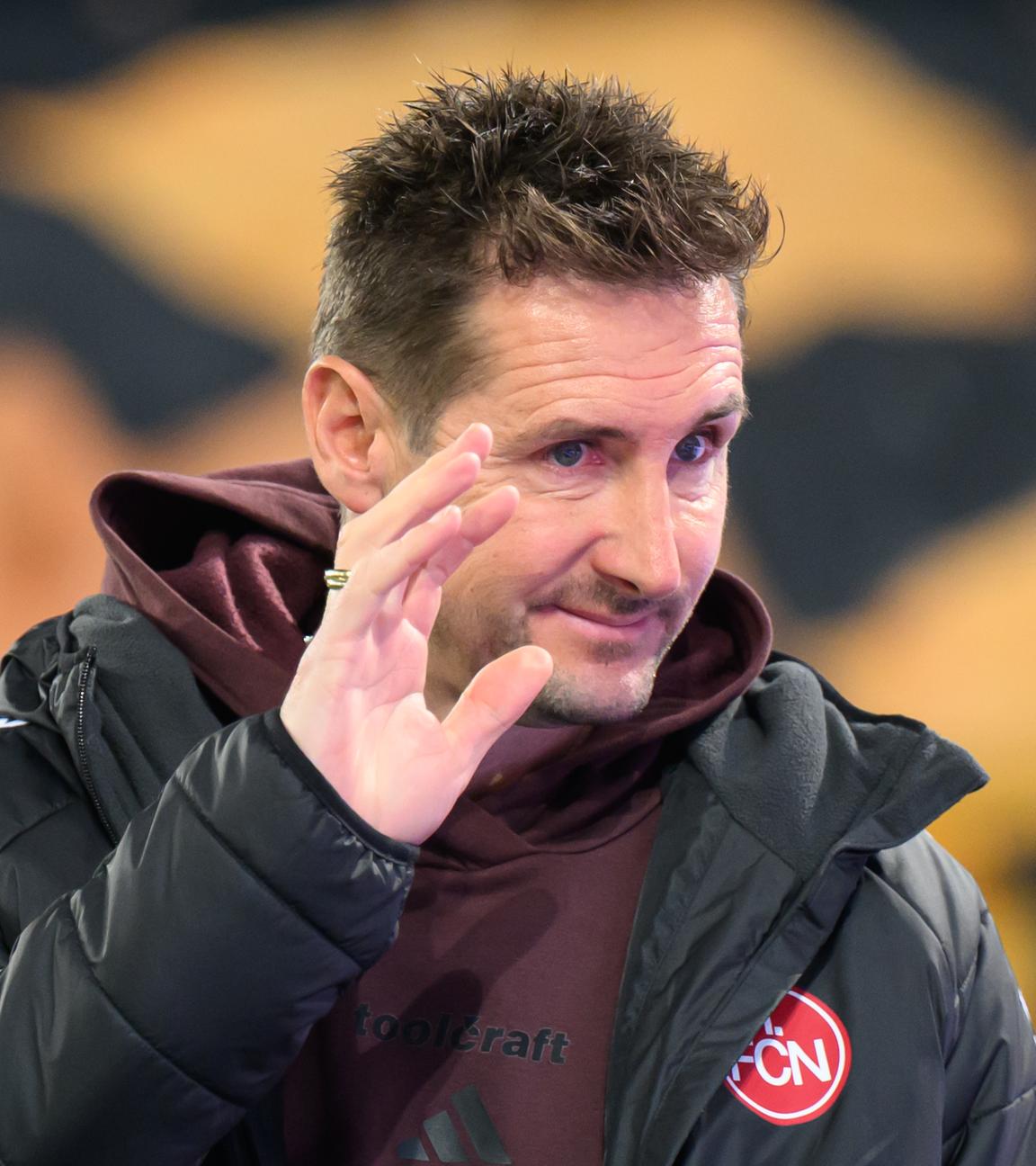 1. FC Nürnbergs Trainer Miroslav Klose macht ein Handzeichen und lächelt