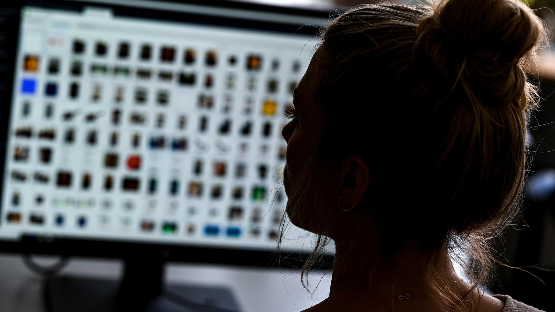 Eine Polizistin sitzt in einem Büro vor einem Auswertungscomputer (Symbolbild).