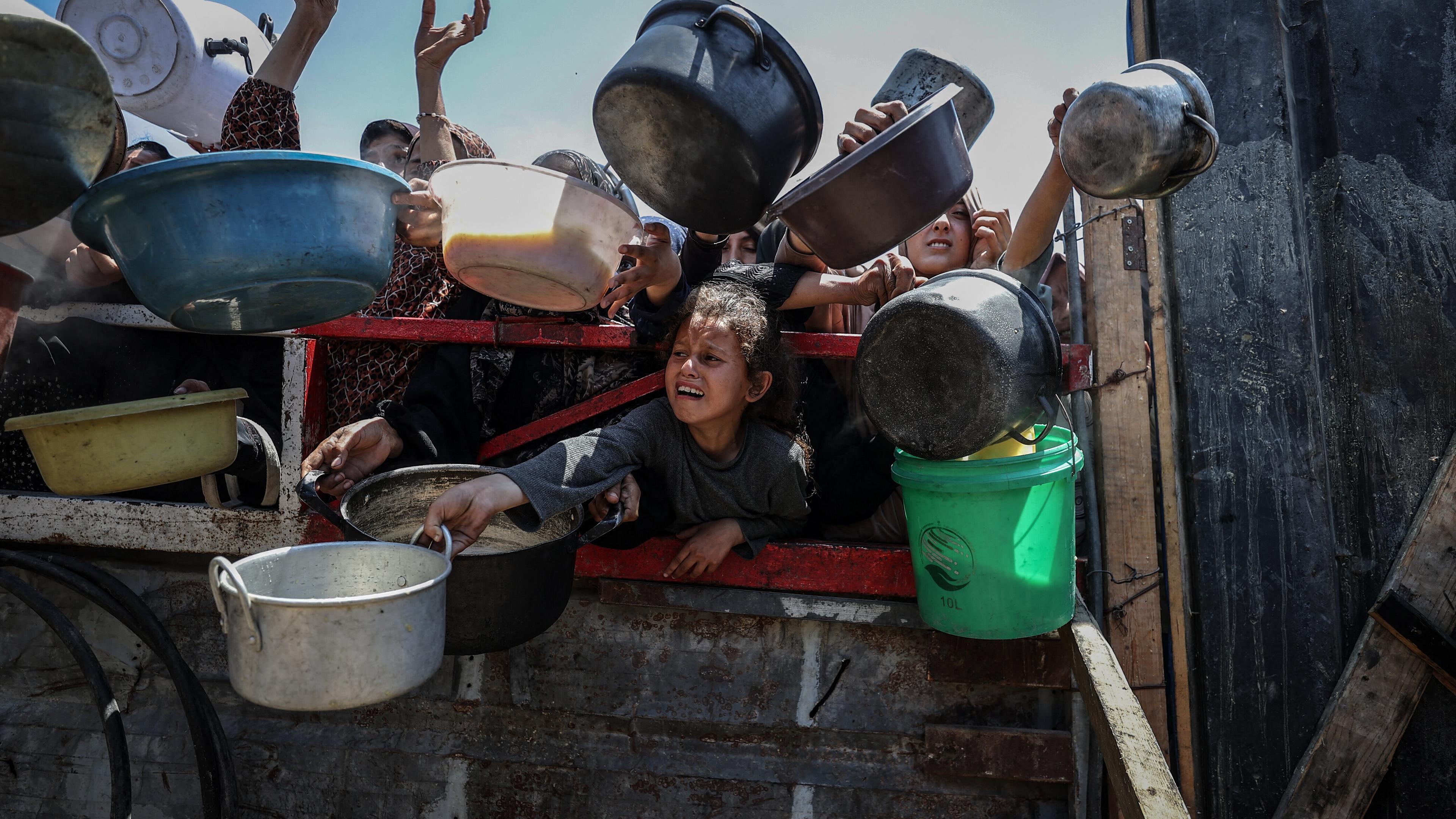 Crowds form as Palestinians, including children, line up in Gaza City