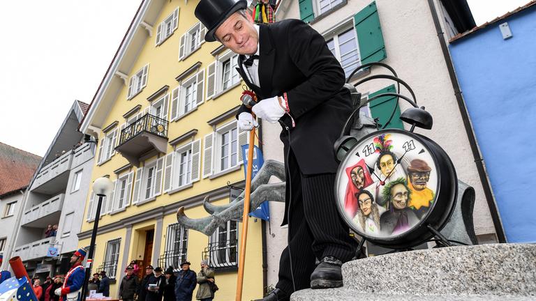 Der sogenannte Fasnetslader von der Narrenzunft Bad Waldsee steht auf dem Narrenbrunnen, und ruft exakt um 11:11 Uhr die Fastnacht aus.
