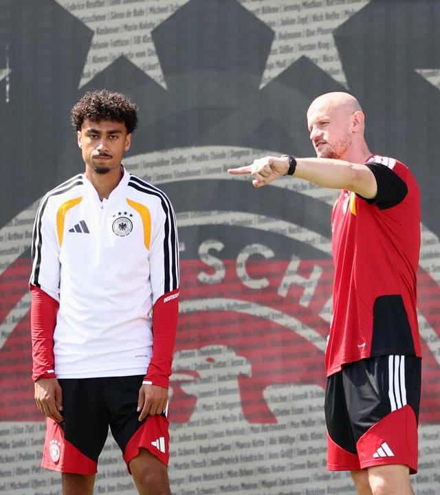 Der deutsche Nationalspieler Nathaniel Brown steht zusammen mit einem Physiotherapeuten auf dem Trainingsplatz in Winston-Salem