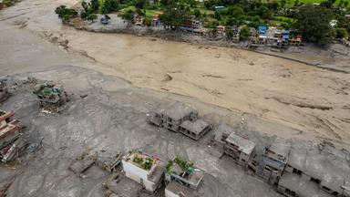 Vogelperspektive auf eine von der Flut zerstörte Siedlung in Nepal. 