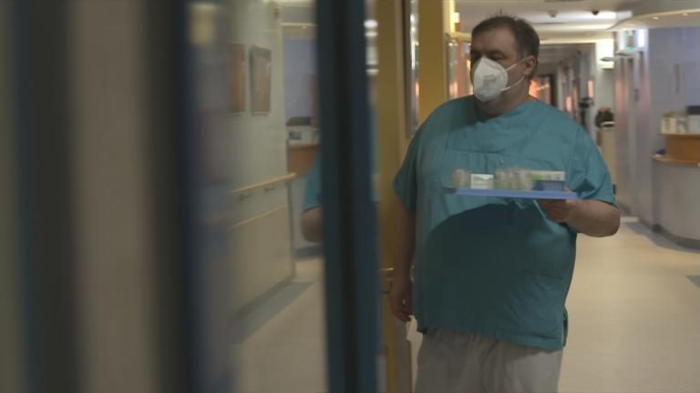 Auf dem Bild sieht man einen Mann im Krankenhaus.