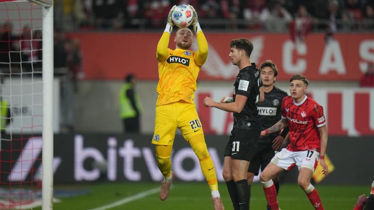 In der Zweitligapartie zwischen dem 1. FC Kaiserslautern und dem SV Elverserg steigt der Torwart der Gäste, Nicolas Kristof, in die Höhe und kann einen Ball sichern