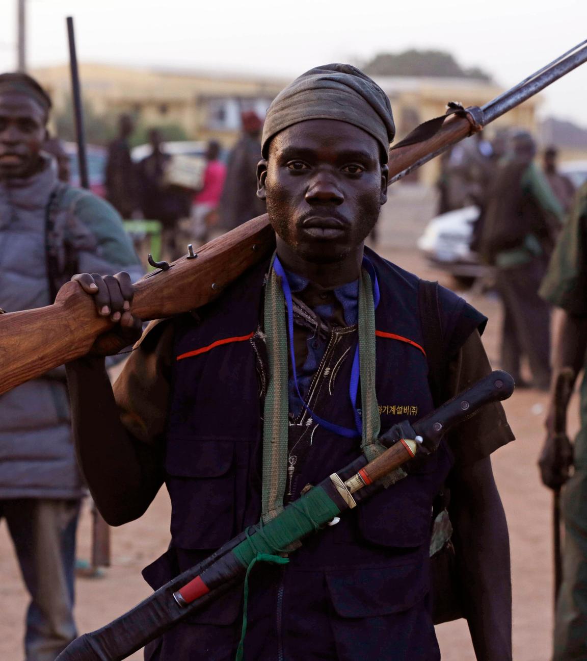  vigilantes and local hunters armed with locally made guns gather before they go on patrol in yola.
