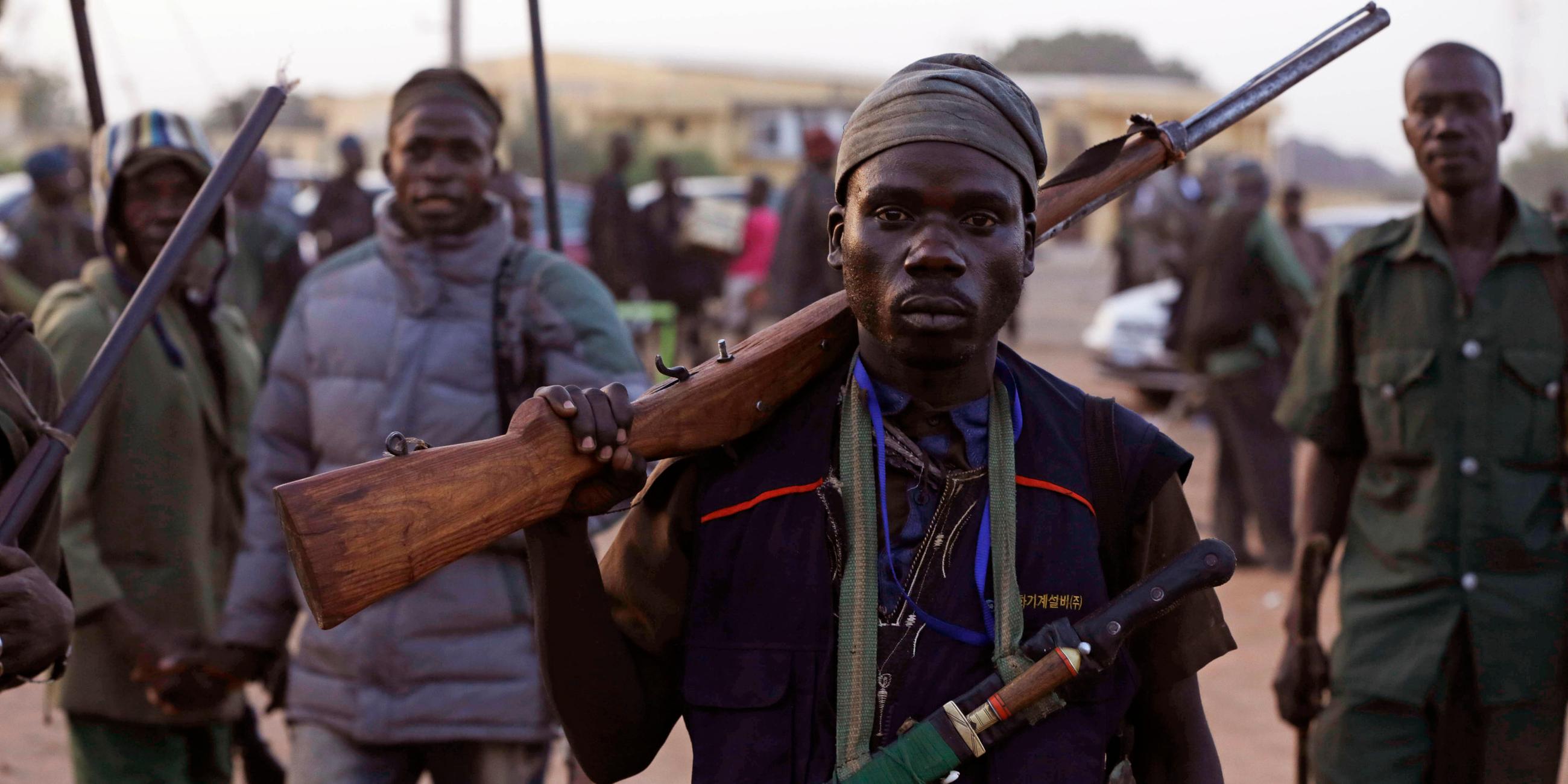 vigilantes and local hunters armed with locally made guns gather before they go on patrol in yola.
