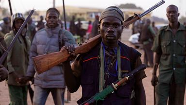  vigilantes and local hunters armed with locally made guns gather before they go on patrol in yola.