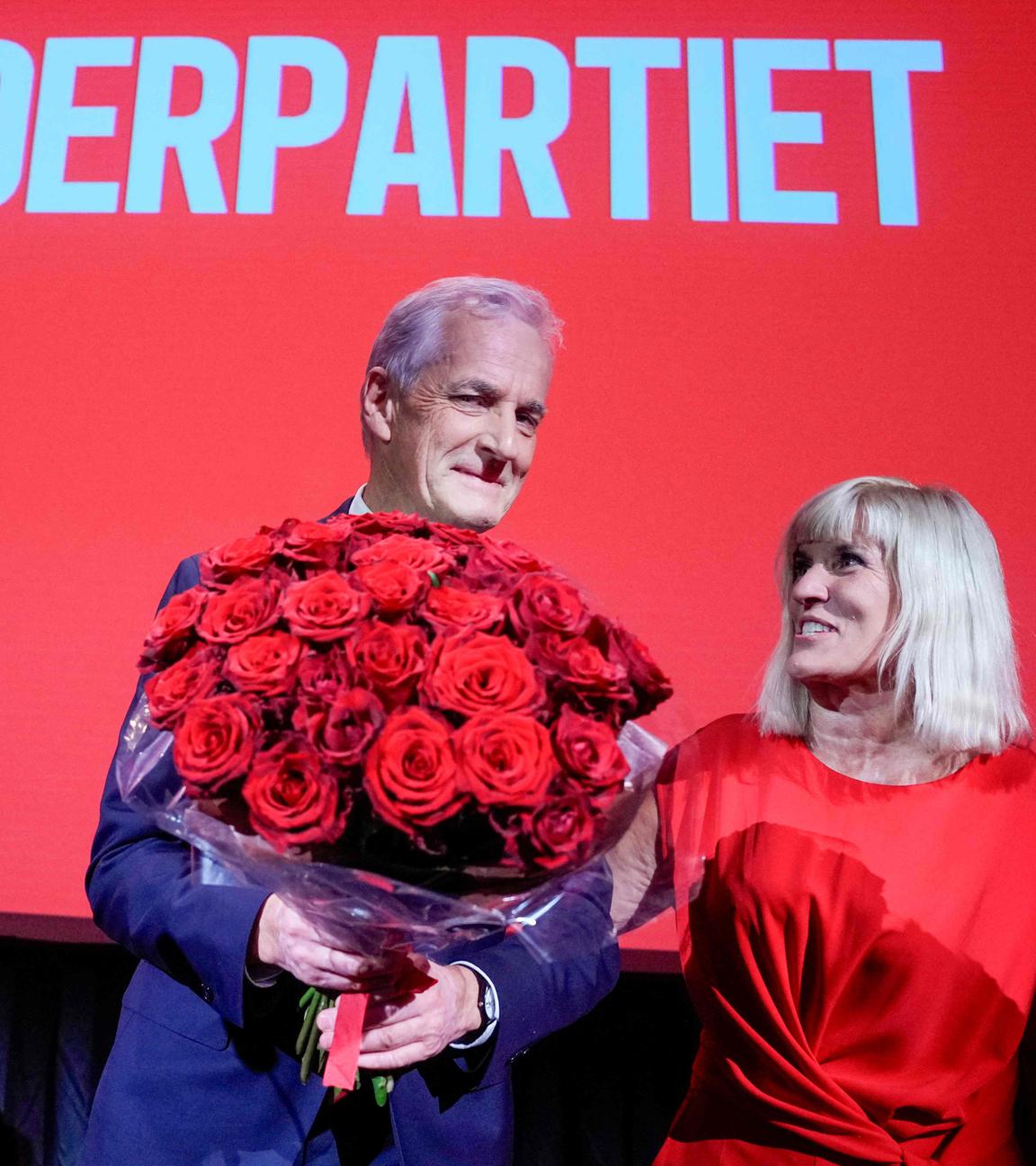 Norway's incumbent Prime Minister and leader of the Labour Party (AP) Jonas Gahr Stoere (L) stands on stage with Kari-Anne Opsal (R) at the party's election vigil at People's House in Oslo, Norway