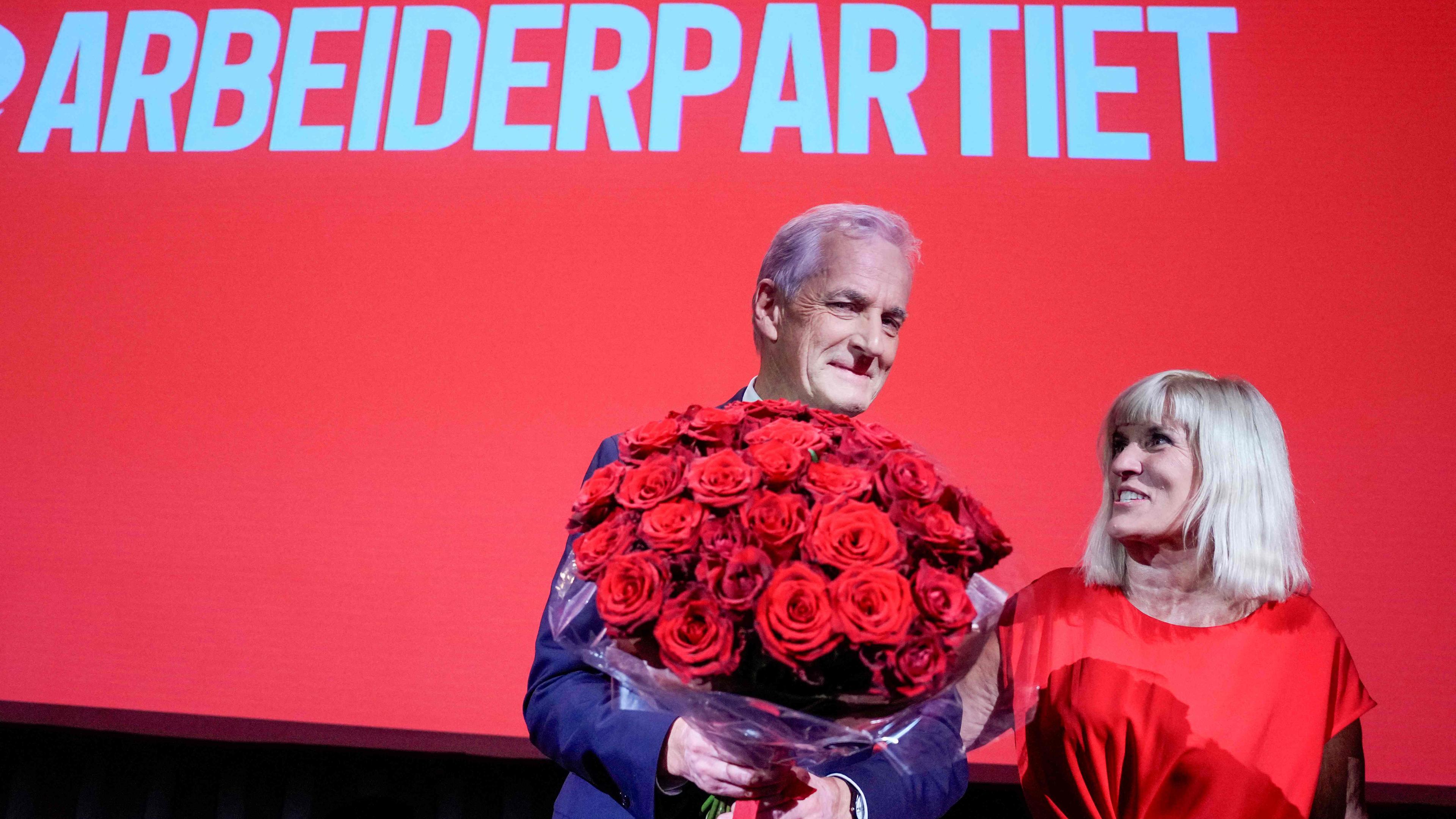 Norway's incumbent Prime Minister and leader of the Labour Party (AP) Jonas Gahr Stoere (L) stands on stage with Kari-Anne Opsal (R) at the party's election vigil at People's House in Oslo, Norway