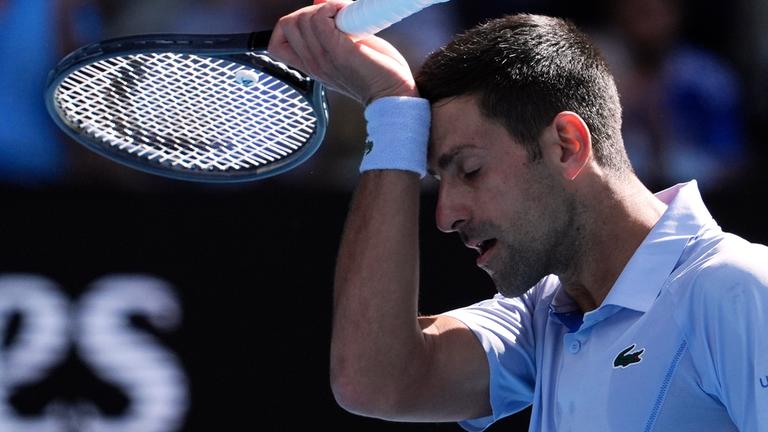 Novak Djokovic wischt sich während seines Halbfinalspiels den Schweiß aus dem Gesicht am 26.01.2024.