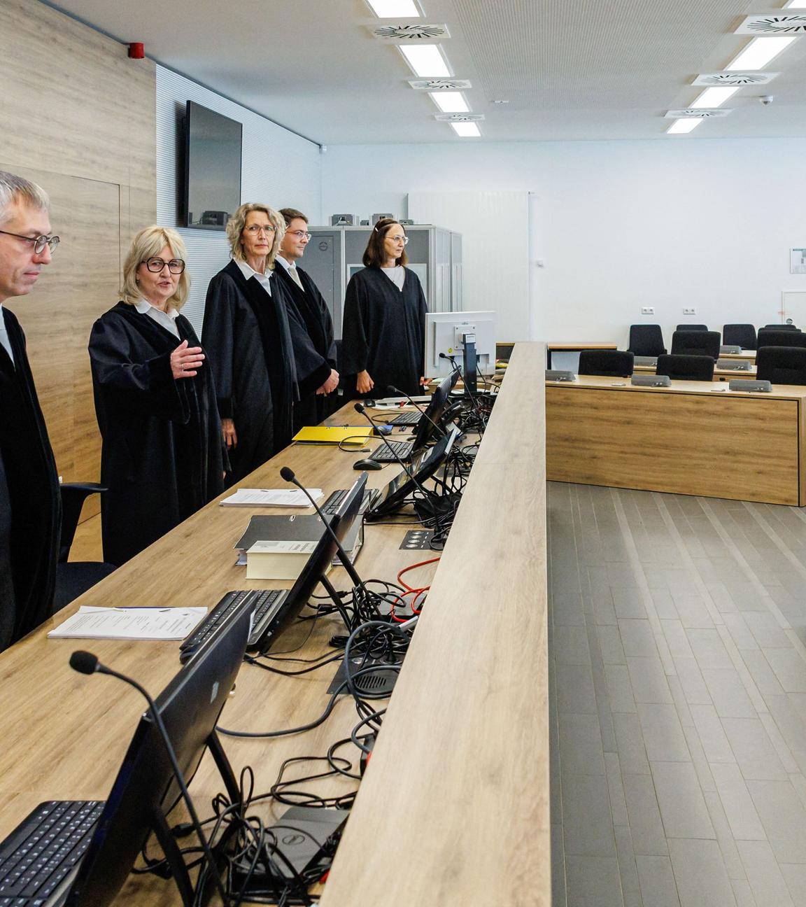 Simone Herberger (2ndL), presiding judge at the Higher Regional Court, stands in the courtroom prior to the start of the trial of Susann E. (2ndR) as suspected supporter of the far-right extremist cell National Socialist Underground (NSU),