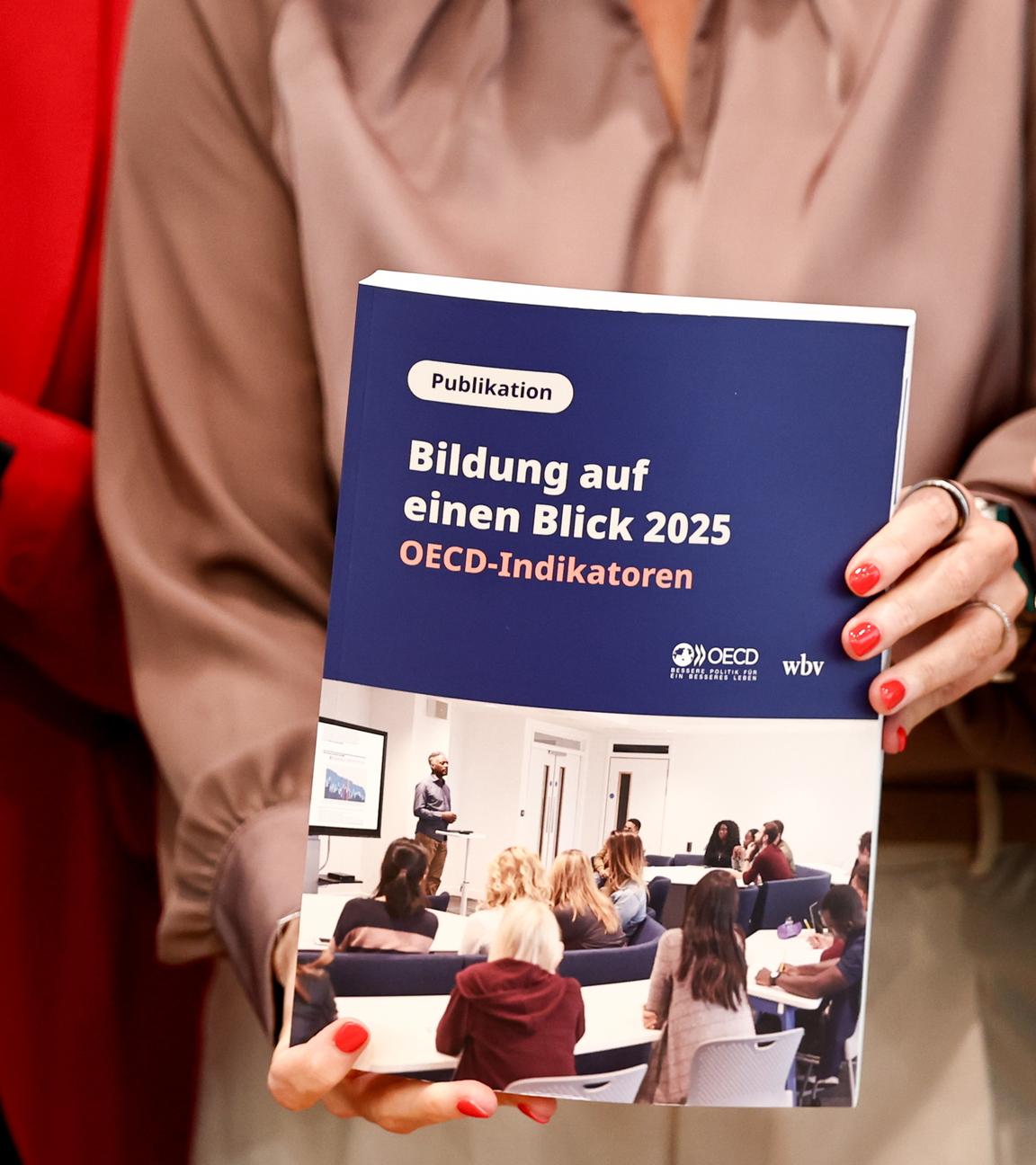 German Minister of Research, Technology and Space Dorothee Baer (R) and Parliamentary State Secretary to the Federal Minister of Education, Family Affairs, Senior Citizens, Women and Youth Mareike Wulf (L) attend a presentation of the Organisation for Economic Co-operation and Development (OECD) Study Education