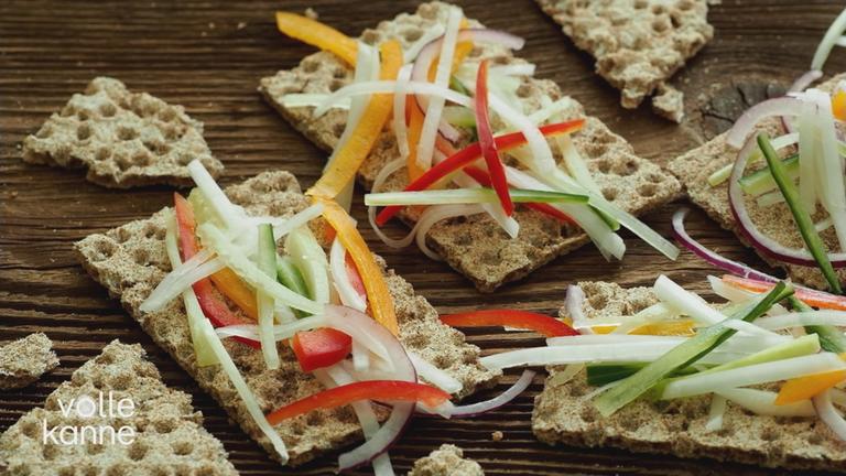 Knäckebrot mit Gemüse-Streifen belegt.