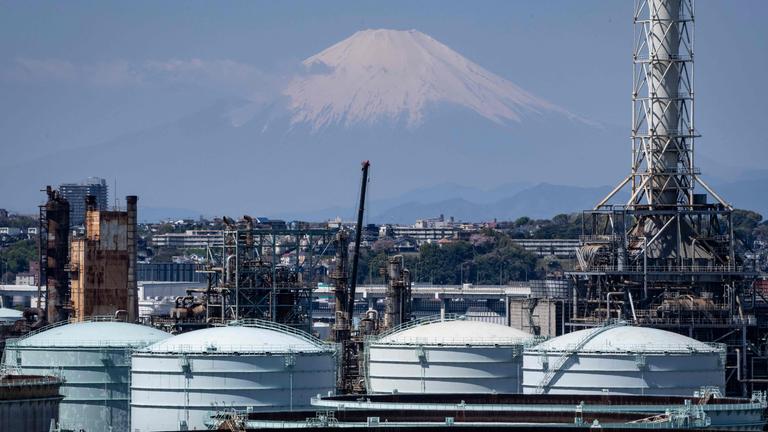 Lagertanks einer Ölraffinerie sind zu sehen, während sich der Berg Fuji im Hintergrund bei Yokohama in der Präfektur Kanagawa erhebt.