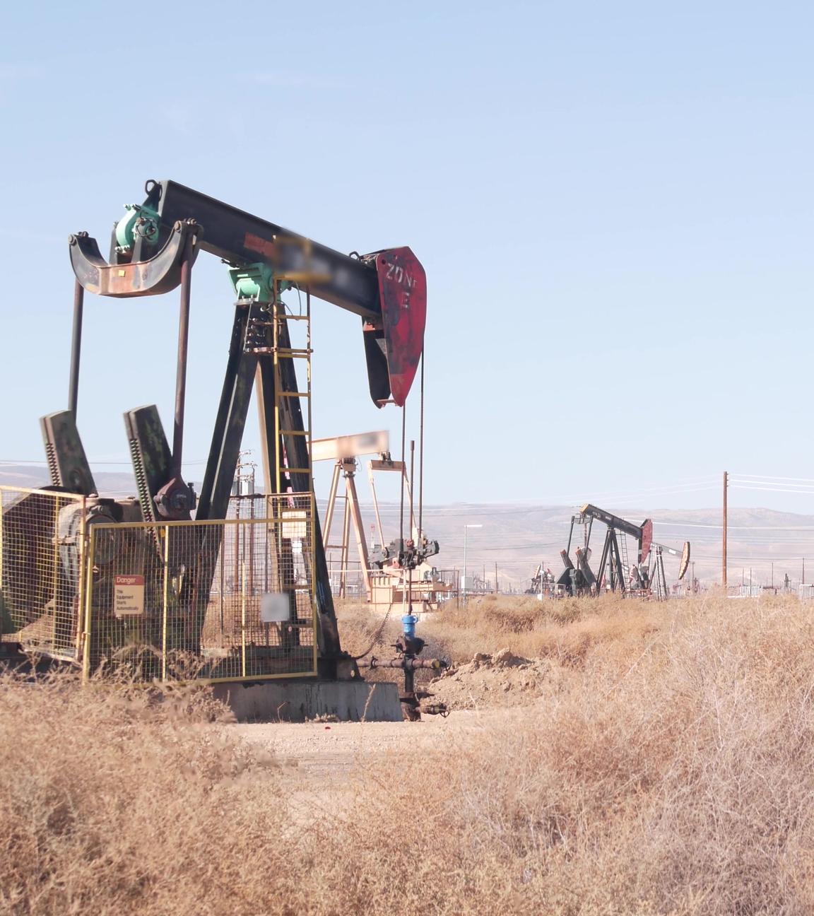 Ölquellen mit Pumpenböcken auf einem Ölfeld in Kalifornien, USA, am 27.06.2022.